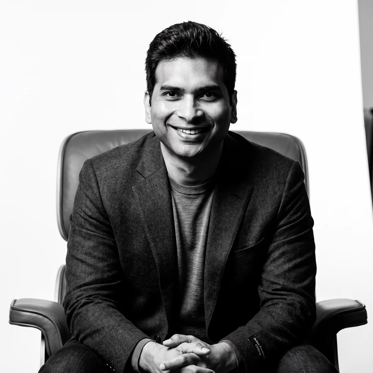 Founder of INX Group seated in a chair